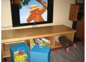 kid stuck under tv